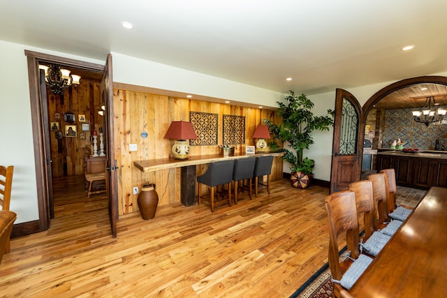 dining room featuring light hardwood / wood-style floors and a notable chandelier