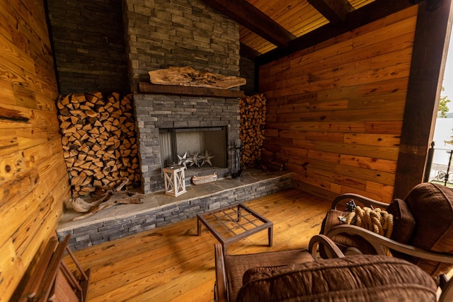 living room featuring hardwood / wood-style flooring, lofted ceiling with beams, wood ceiling, and a fireplace