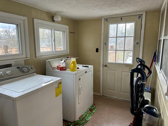 laundry room featuring a textured ceiling and separate washer and dryer