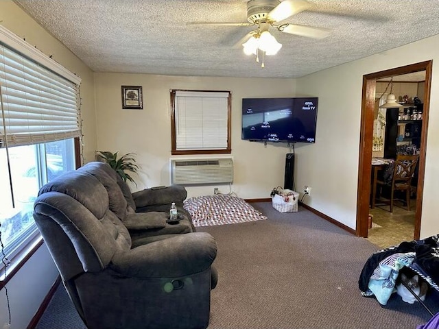 carpeted living room with an AC wall unit, ceiling fan, and a textured ceiling