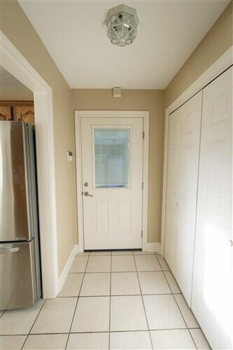 doorway to outside with light tile patterned floors