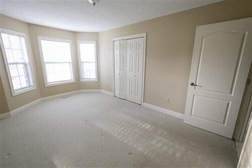 unfurnished bedroom with light colored carpet