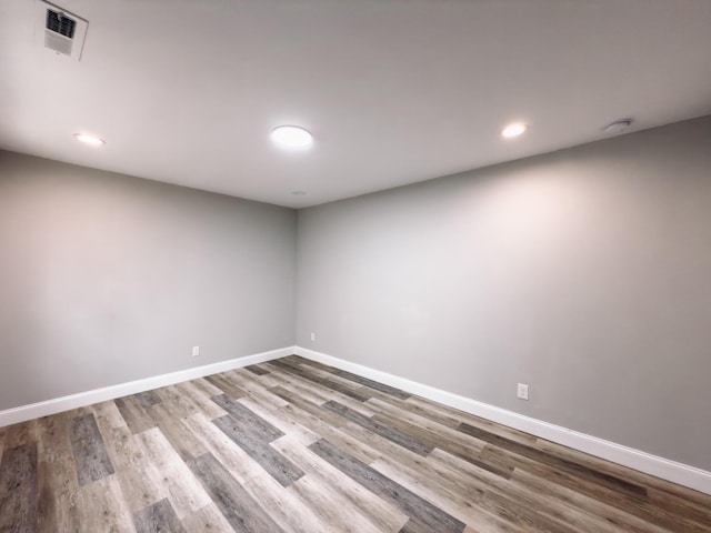 spare room featuring recessed lighting, visible vents, baseboards, and wood finished floors