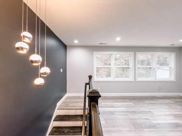 stairway featuring recessed lighting, visible vents, baseboards, and wood finished floors