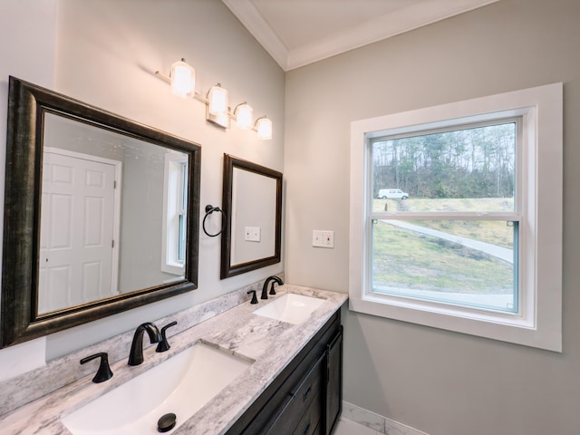 bathroom featuring plenty of natural light, ornamental molding, and vanity