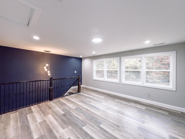 unfurnished room featuring recessed lighting, visible vents, baseboards, and wood finished floors