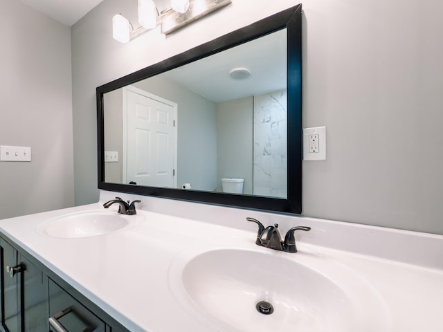 bathroom featuring vanity and toilet