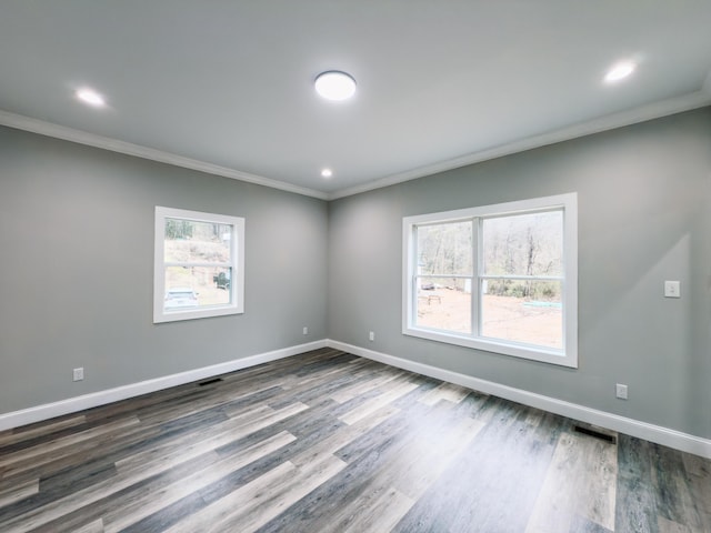 unfurnished room featuring dark hardwood / wood-style floors and ornamental molding