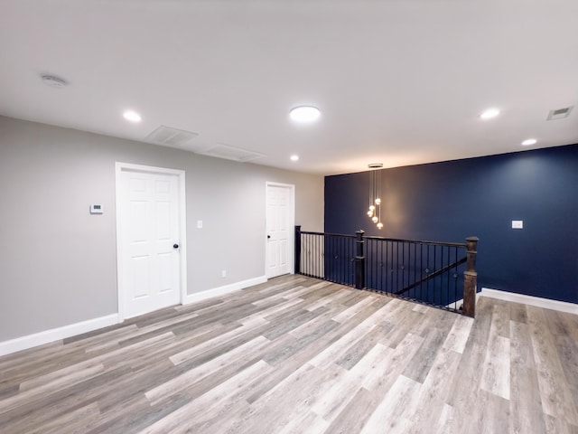 empty room with recessed lighting, visible vents, light wood-style flooring, and baseboards