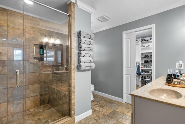 bathroom with vanity, toilet, walk in shower, and ornamental molding