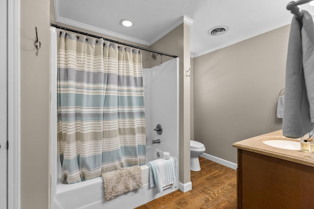 full bathroom featuring crown molding, hardwood / wood-style floors, toilet, vanity, and shower / tub combo