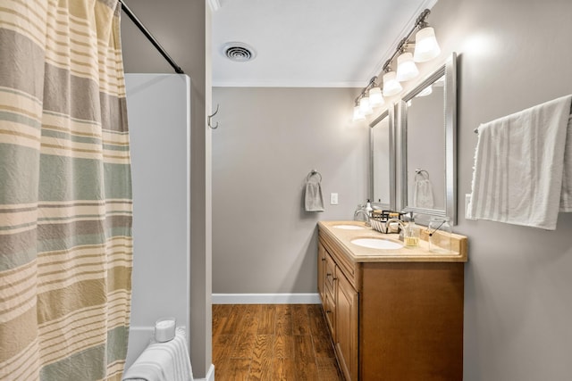 bathroom featuring hardwood / wood-style flooring, vanity, ornamental molding, and a shower with shower curtain