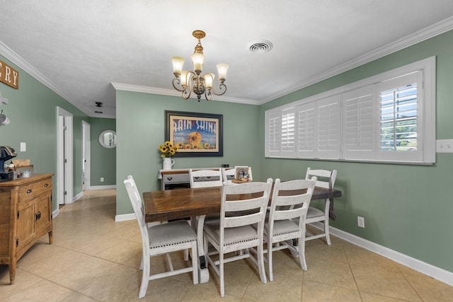 dining area with light tile patterned flooring, ornamental molding, and an inviting chandelier