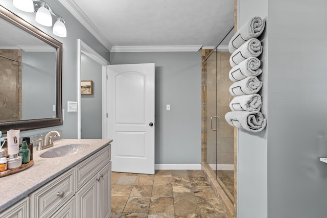 bathroom featuring vanity, a shower with door, and crown molding