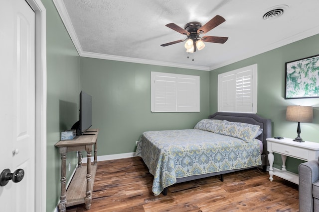 bedroom with hardwood / wood-style flooring, ceiling fan, crown molding, and a textured ceiling