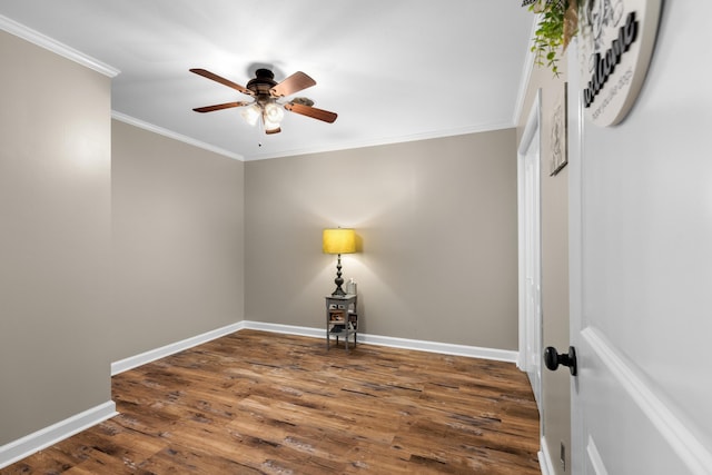 spare room with dark hardwood / wood-style floors, ceiling fan, and ornamental molding