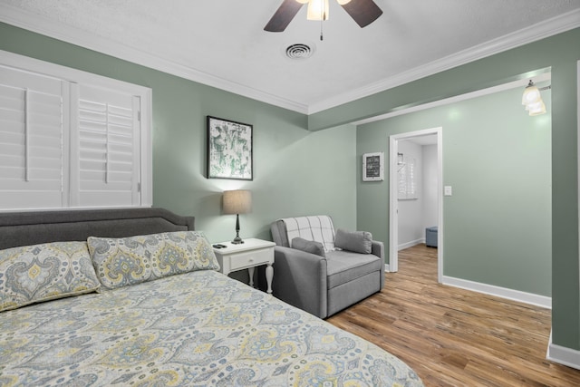 bedroom featuring ceiling fan, hardwood / wood-style floors, and ornamental molding