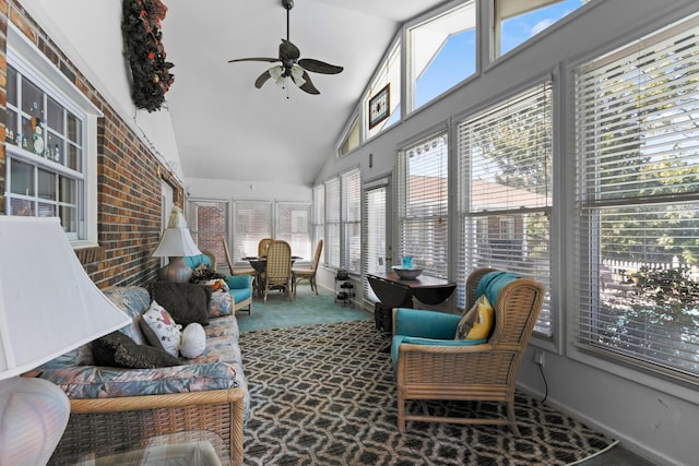 sunroom with ceiling fan, a healthy amount of sunlight, and lofted ceiling