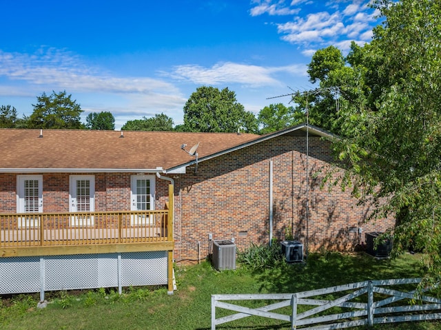 rear view of property featuring a deck and central air condition unit