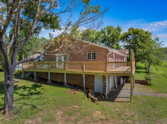 back of property featuring a yard and a wooden deck