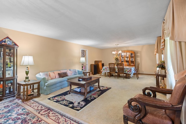 carpeted living room featuring a notable chandelier