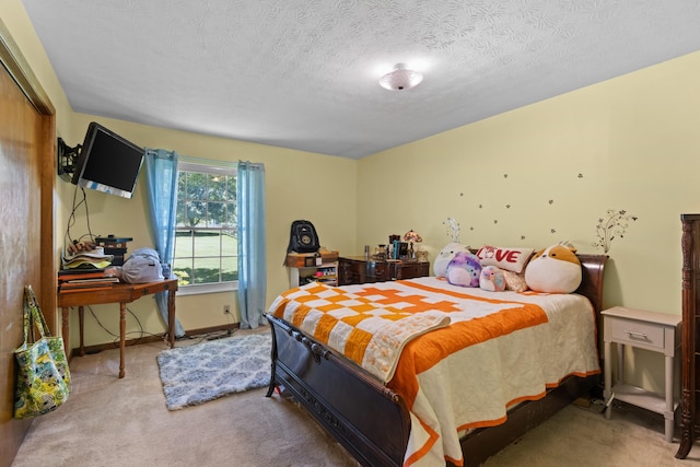 carpeted bedroom featuring a textured ceiling