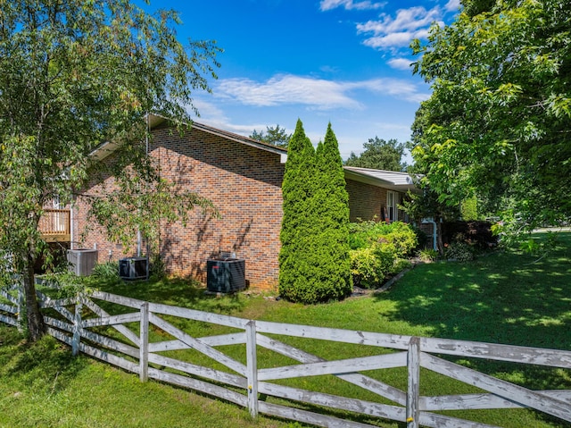 view of property exterior featuring a lawn and central AC unit