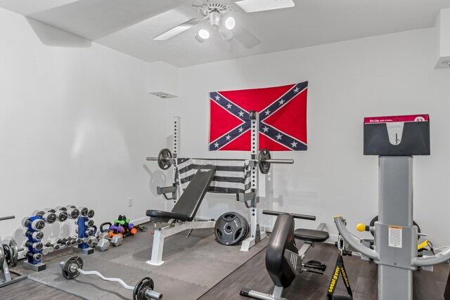 workout area with a ceiling fan and baseboards