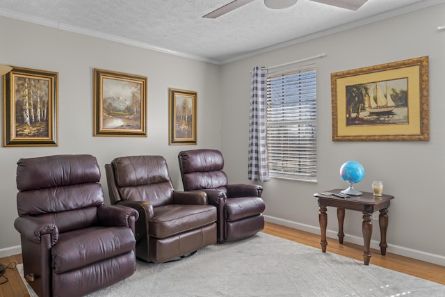 cinema featuring a textured ceiling, ceiling fan, wood finished floors, and baseboards