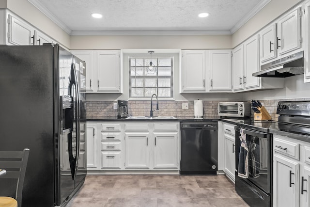 kitchen featuring dark countertops, white cabinetry, a sink, under cabinet range hood, and black appliances