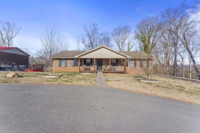 ranch-style house featuring a porch and brick siding