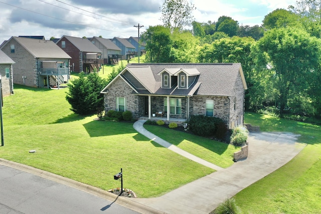 view of front of house with driveway, brick siding, a residential view, a front yard, and a porch