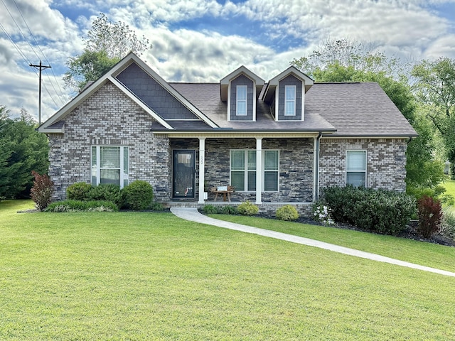 craftsman inspired home featuring covered porch, brick siding, and a front lawn