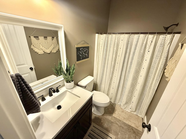 bathroom featuring toilet, vanity, and a shower with curtain