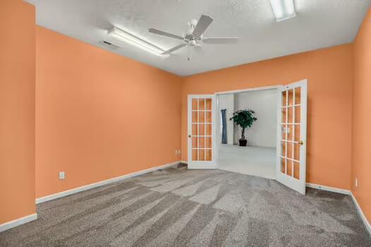 784 Constitution Dr, Jefferson City, TN 37760 - empty room featuring visible vents, a ceiling fan, baseboards, french doors, and carpet