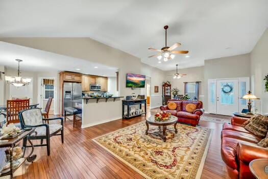 784 Constitution Dr, Jefferson City, TN 37760 - living room with vaulted ceiling, wood finished floors, and ceiling fan with notable chandelier