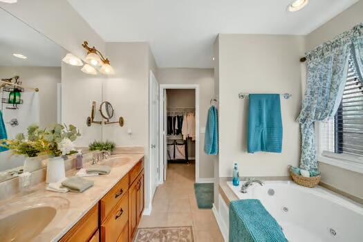 784 Constitution Dr, Jefferson City, TN 37760 - full bathroom featuring tile patterned flooring, a sink, a jetted tub, double vanity, and a walk in closet