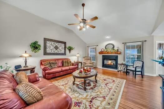 784 Constitution Dr, Jefferson City, TN 37760 - living area with a warm lit fireplace, a ceiling fan, vaulted ceiling, and wood finished floors