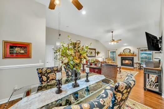 784 Constitution Dr, Jefferson City, TN 37760 - dining space featuring lofted ceiling, a lit fireplace, a ceiling fan, and wood finished floors