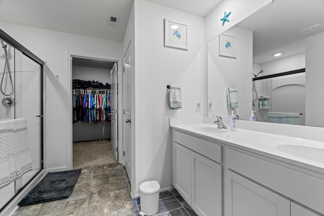 1065 Greenway Dr, Morristown, TN 37813 - full bath with double vanity, stone finish flooring, a shower stall, and a sink