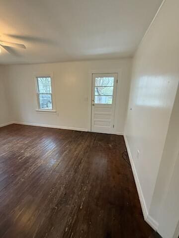 interior space with baseboards and wood finished floors