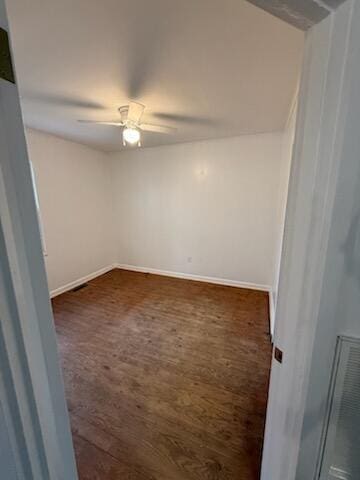 spare room featuring visible vents, ceiling fan, baseboards, and wood finished floors