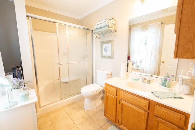 bathroom with ornamental molding, toilet, tile patterned floors, a shower with door, and vanity