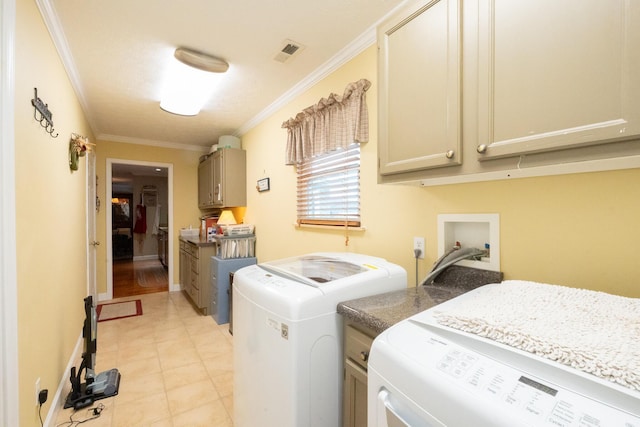 clothes washing area with independent washer and dryer, cabinets, and crown molding