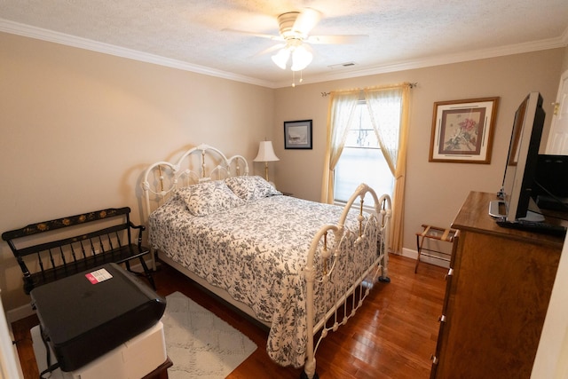 bedroom featuring ceiling fan, dark hardwood / wood-style flooring, ornamental molding, and a textured ceiling