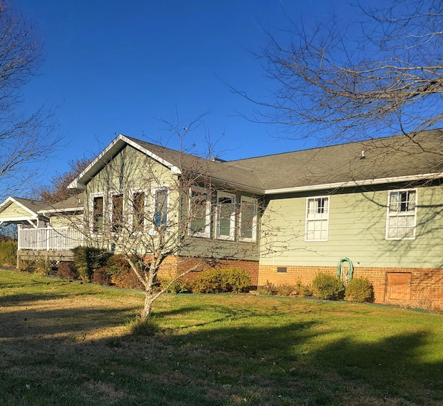 view of property exterior with a yard