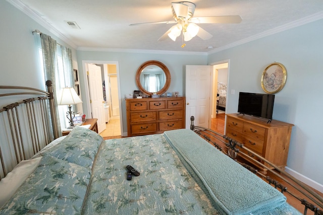 bedroom with ensuite bath, ceiling fan, multiple windows, and ornamental molding