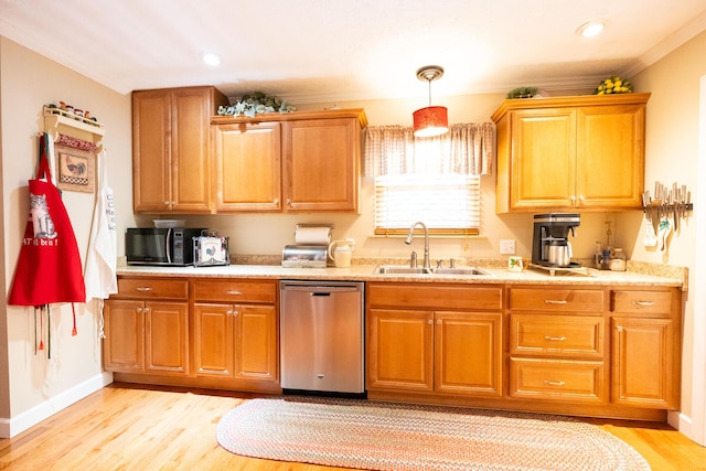 kitchen featuring sink, dishwasher, hanging light fixtures, and light hardwood / wood-style flooring