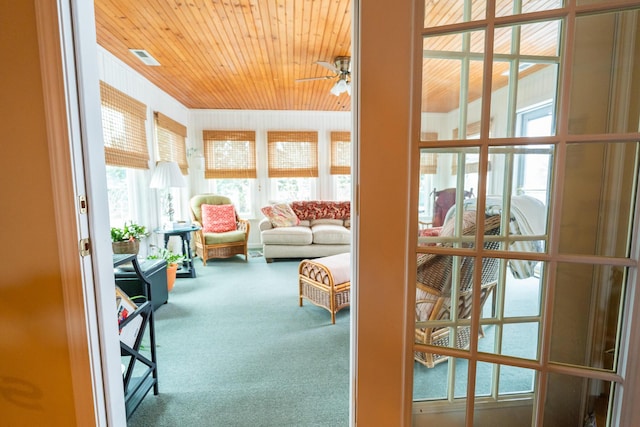 sunroom featuring wooden ceiling and ceiling fan