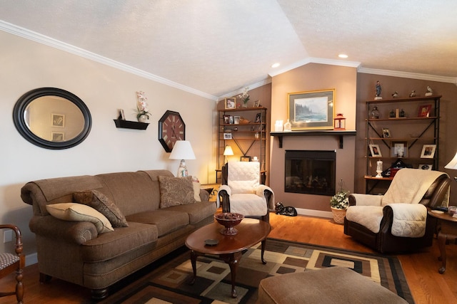 living room featuring lofted ceiling, hardwood / wood-style floors, a textured ceiling, and ornamental molding